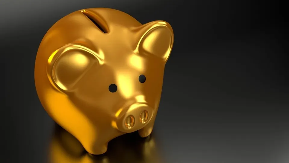 Gold piggy bank on a dark background
