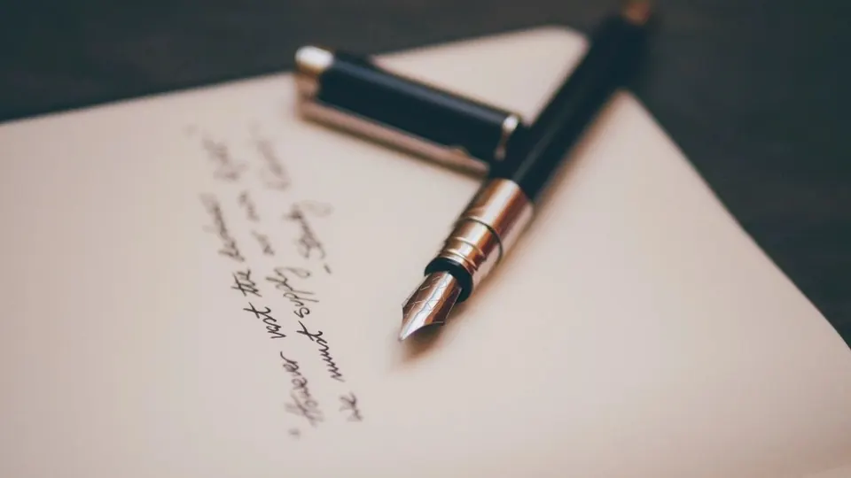 Fountain pen resting on a handwritten letter